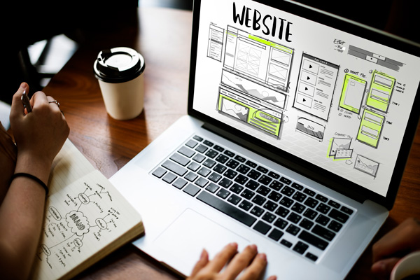 Website Design and Development Wireframe on Laptop